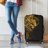 Black luggage cover with golden ornate skull face on a rolling four-wheeled suitcase