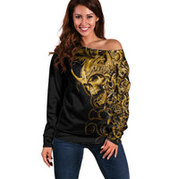 Black off-shoulder sweater with gold skull and ornate graphic, long sleeves