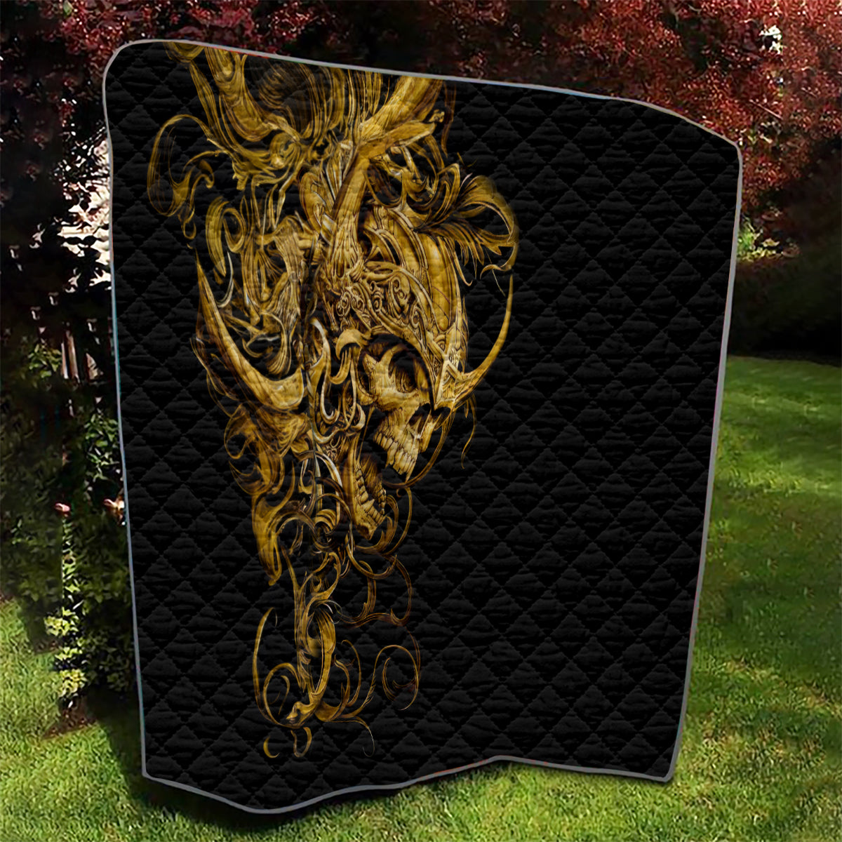 Black quilt featuring golden warrior skull artwork on a quilted diamond texture