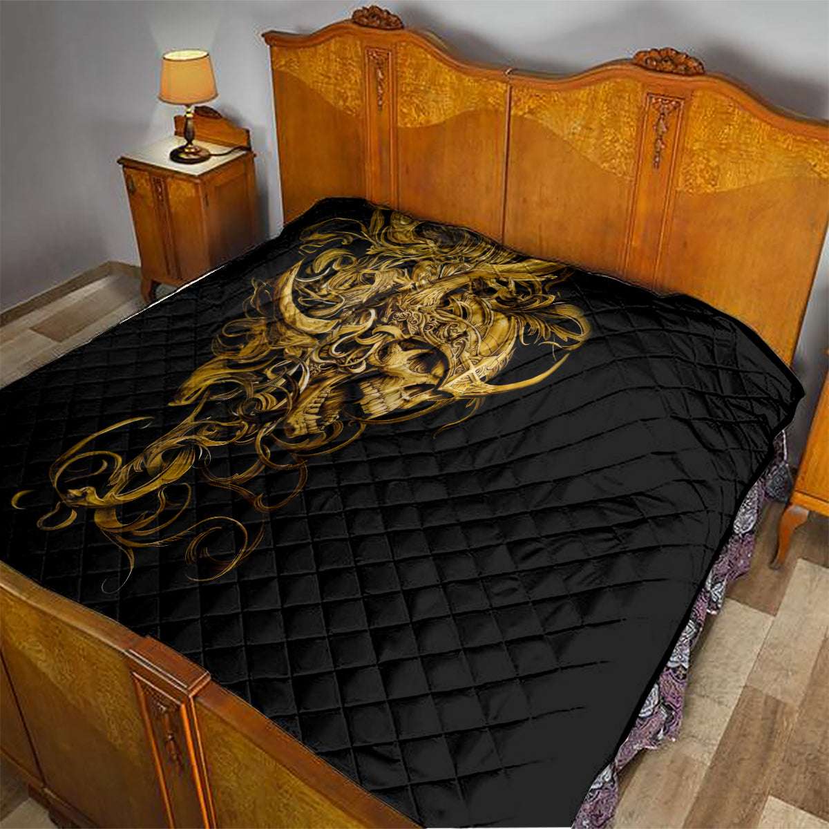 Black quilt on bed with golden warrior skull graphic across the quilted surface