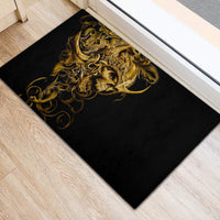 Black rubber doormat featuring gold skull warrior design in ornate curls