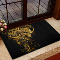 Black rubber doormat with gold skull warrior artwork, angled view