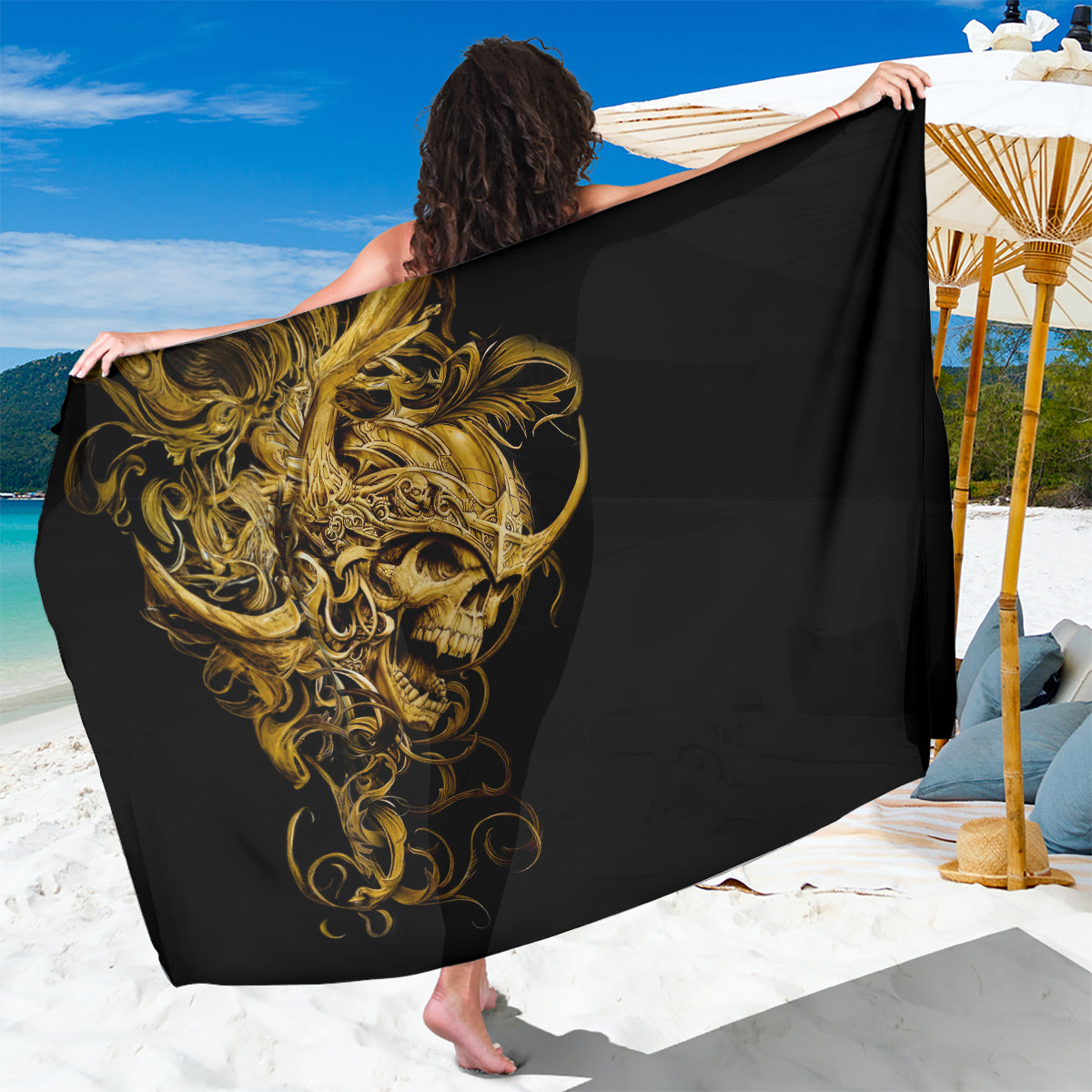 Black sarong with gold skull and warrior design, draped as a beach wrap