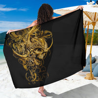Black sarong with gold skull and warrior design, draped as a beach wrap