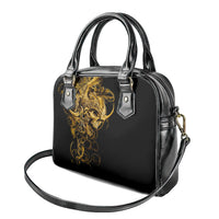 Black structured handbag with gold warrior graphic, silver-tone top handles