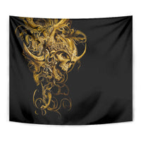 Close-up of black tapestry showing golden skull warrior face with swirling filigree