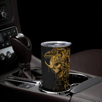 Black tumbler cup with gold skull warrior graphic and clear screw-top lid on center console.