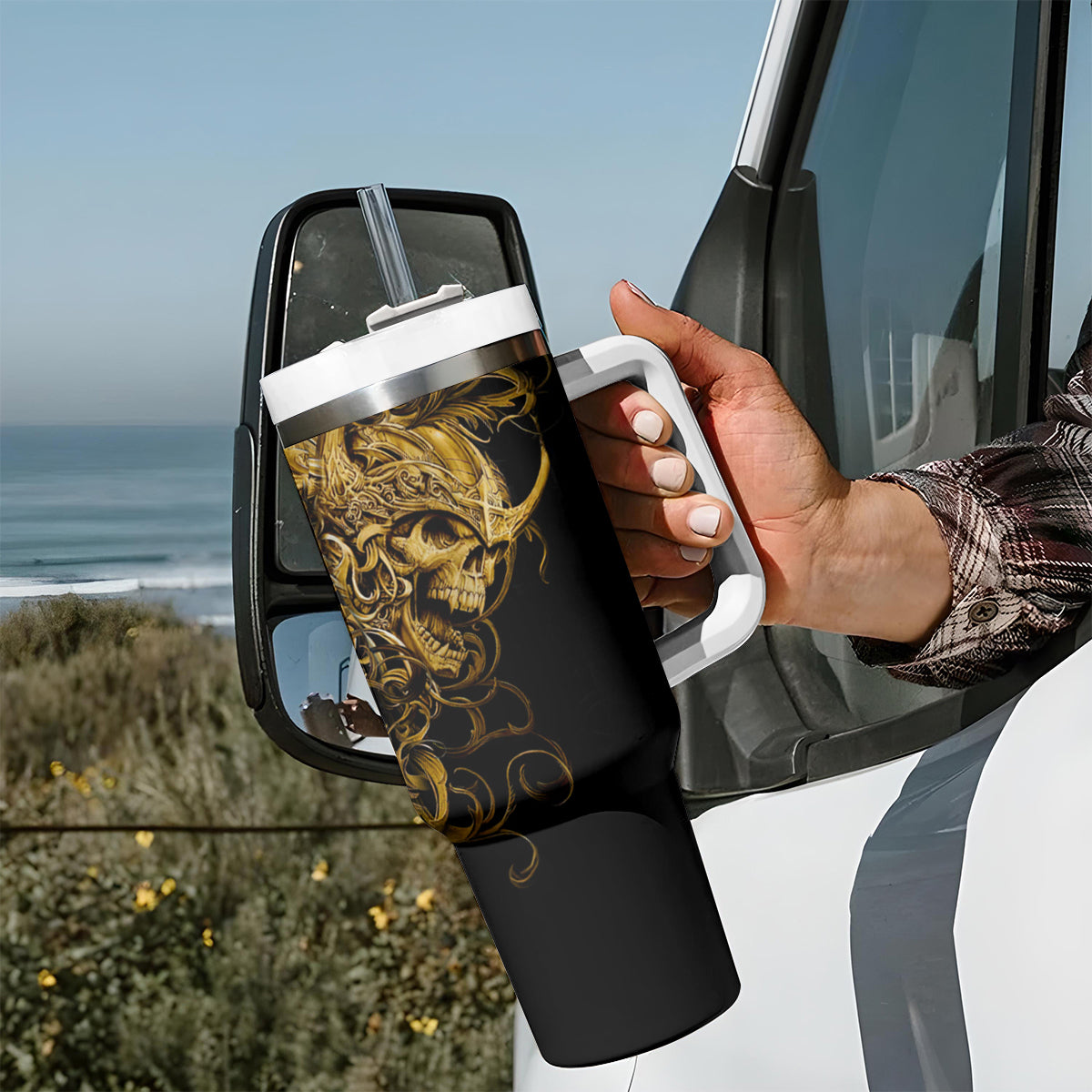 Black skull tumbler with handle, gold warrior skull artwork, white lid and straw