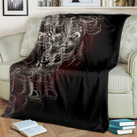Black skull blanket with silver skull face and red flame scroll pattern, draped over furniture