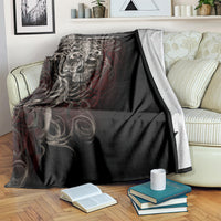 Black skull blanket with silver ornate skull and red accents, folded over seat