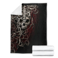 Black skull blanket with silver skull and red flame scroll graphic, folded with rolled sets