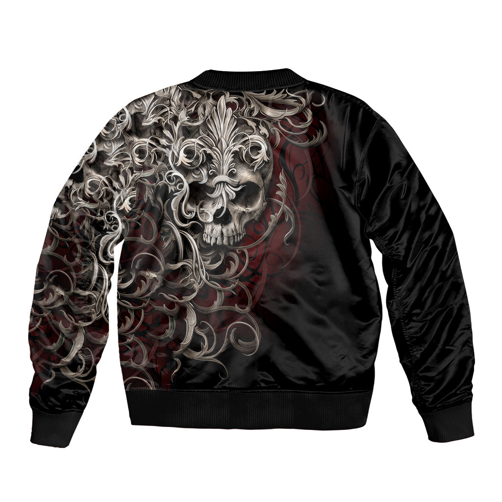 Black bomber jacket with large silver skull back print and swirling ornamental pattern.