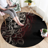 Round black area rug featuring silver skull face with red ornate swirls, full view