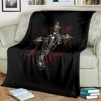 Black skull cross blanket on cream couch, showing central skeletal cross design