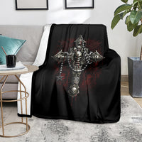 Black skull cross blanket on gray armchair, featuring detailed skeleton emblem