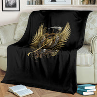 Black throw blanket with golden steampunk skull, wings, and sword motif