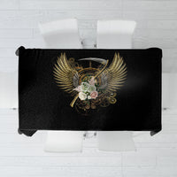 Black tablecloth with golden steampunk skull and wing emblem, folded for display