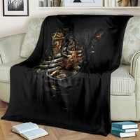 Black steampunk skeleton blanket folded on sofa with metallic chest emblem