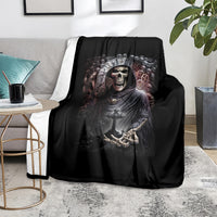 Black skull grim reaper graphic blanket on a sofa, crown and skeletal hands front design