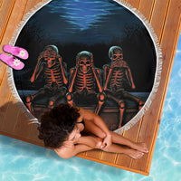Black round beach blanket with fringed edge, three skeletons in a row, glowing eyes.