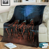 Black skeleton skull throw blanket over armchair, blue wave and three orange figures