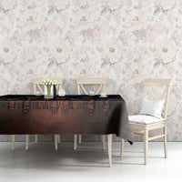 Black tablecloth with skeleton skull artwork spanning the dining table