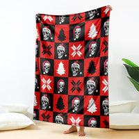 Red and black Christmas blanket with skeleton faces, trees, snowflake icons, and hats
