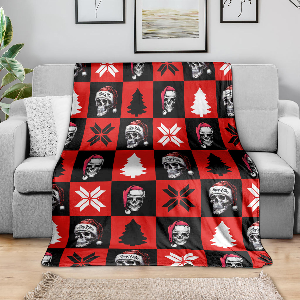 Red check Christmas blanket on sofa, featuring skeleton faces, pine trees, and snowflakes