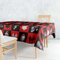 Red skeleton Christmas tablecloth draped over table with skull, tree, and snowflake pattern