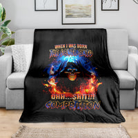 Black flame skull blanket with colorful fiery text, spread over sofa