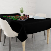 Black tablecloth on dining table with colorful festive skeleton Santa graphic