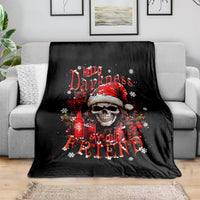 Black skull Santa Claus blanket draped over gray sofa, red holiday print