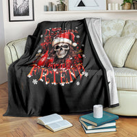 Black skull Santa Claus blanket with red skull Santa graphic, lying on couch