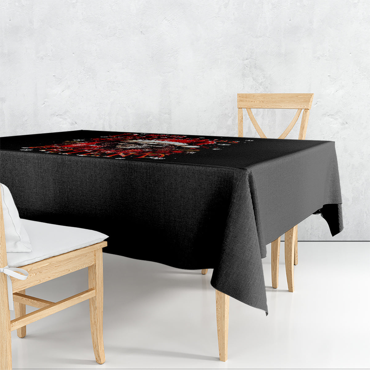 Black tablecloth draped over dining table, with red and white graphic along the top.