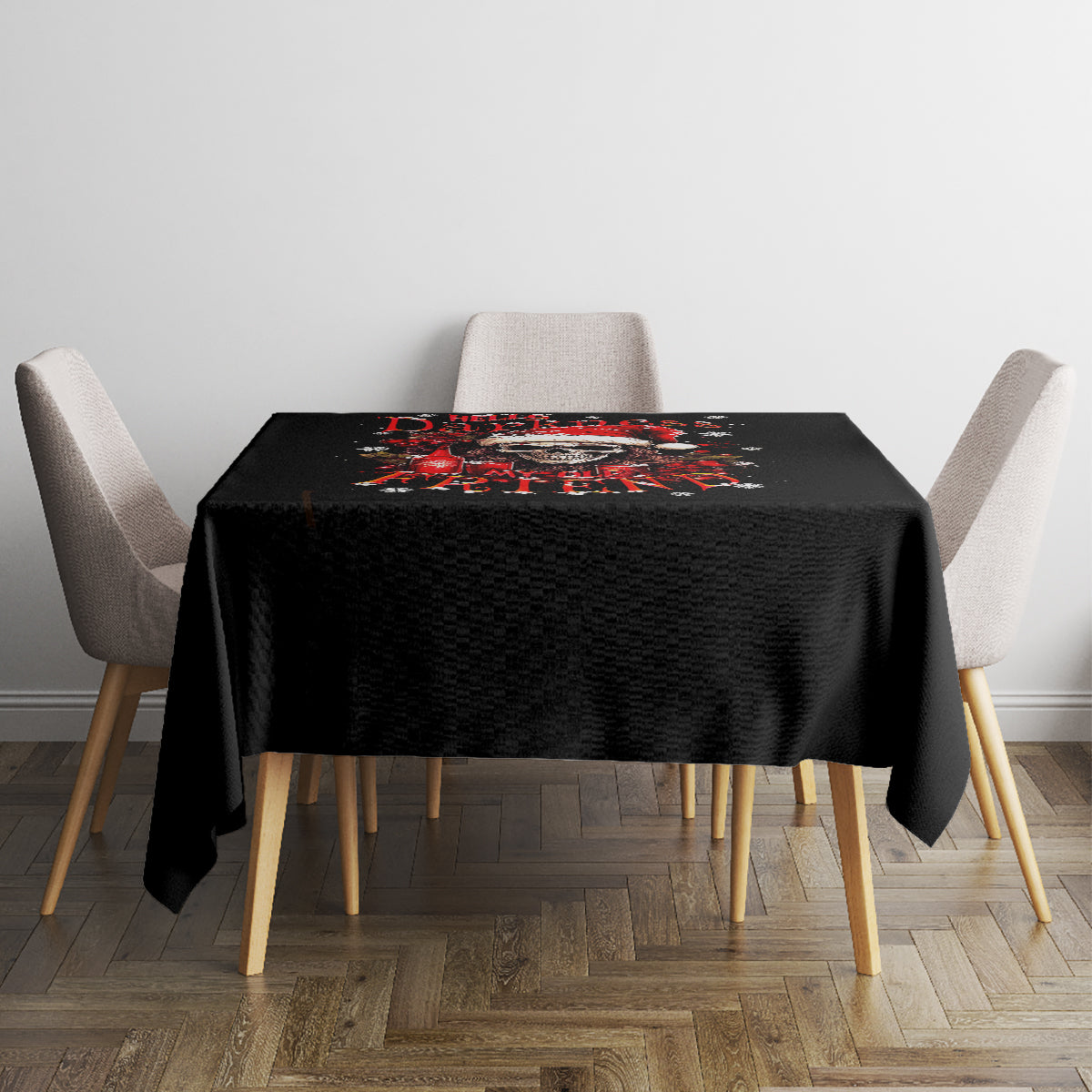 Black tablecloth covering square table, featuring red skull Santa graphic in the center.