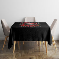 Black tablecloth covering square table, featuring red skull Santa graphic in the center.