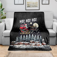 Black holiday throw blanket featuring skeleton Santa, village and snowy trees
