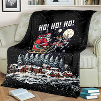 Black Christmas blanket draped over couch with skeleton Santa and moon scene
