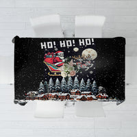 Black holiday tablecloth with snowy Santa skeleton scene and “HO! HO! HO!” text