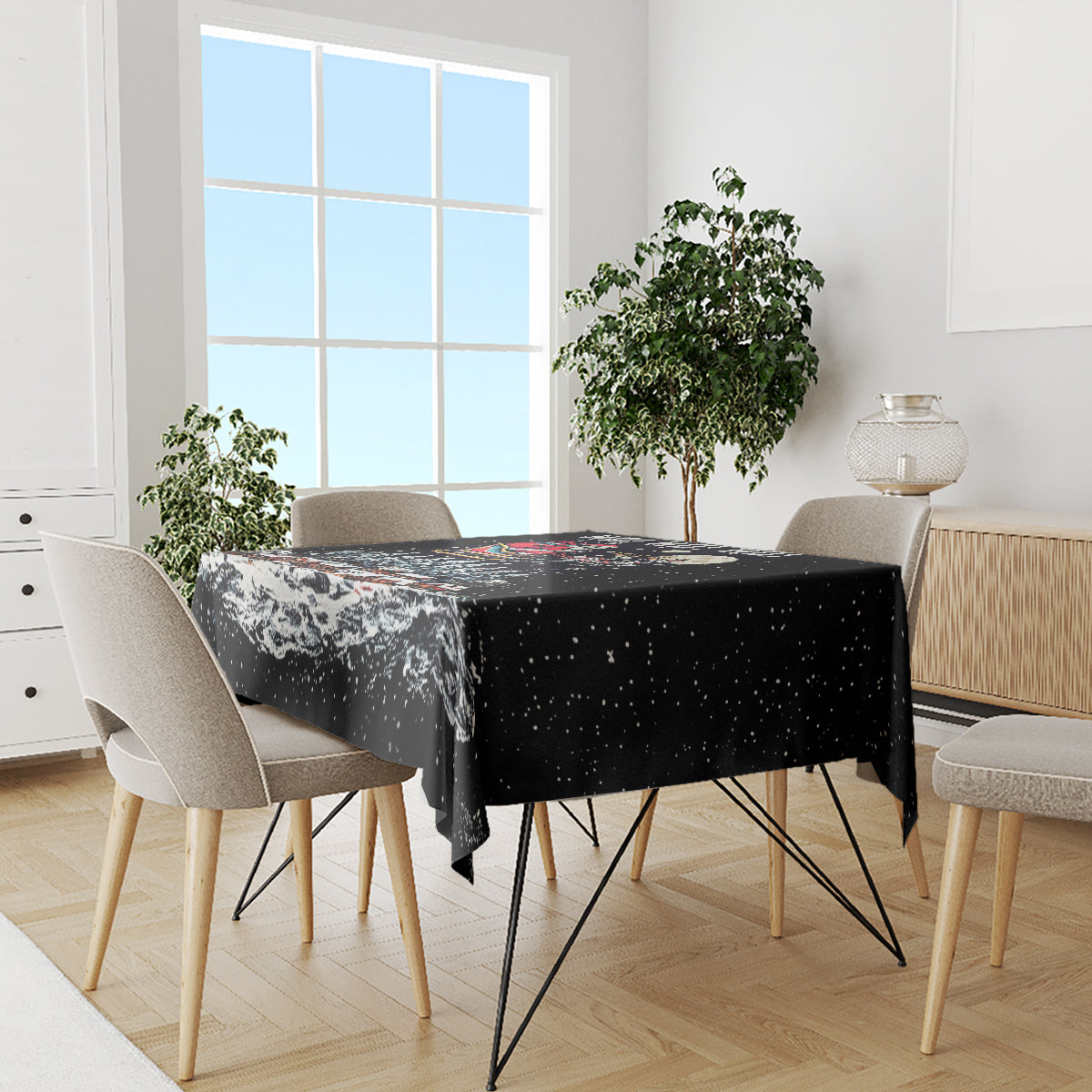 Black seasonal tablecloth on dining table, featuring snowy skeleton Santa and icons