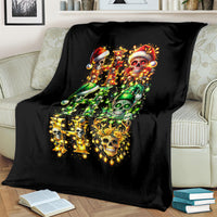 Black blanket featuring colorful sugar skull Santa scene with glowing ornaments and green skulls