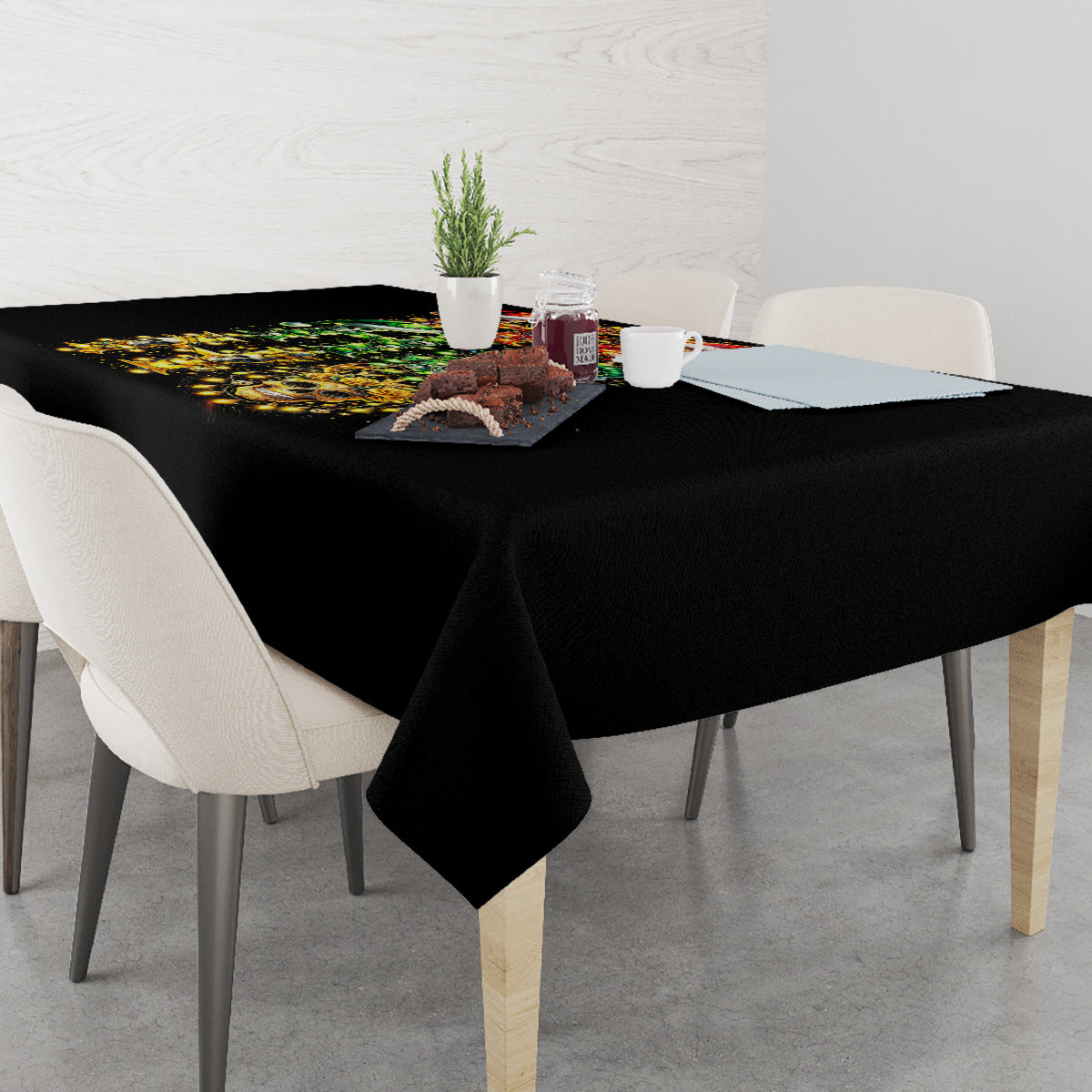 Black tablecloth with colorful sugar skull Santa print, corner view with chairs