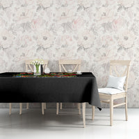 Black tablecloth with colorful skeleton Santa and candy-themed holiday print.