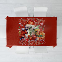 Red holiday tablecloth with skeleton Santa graphic and “Ho Ho Ho” text