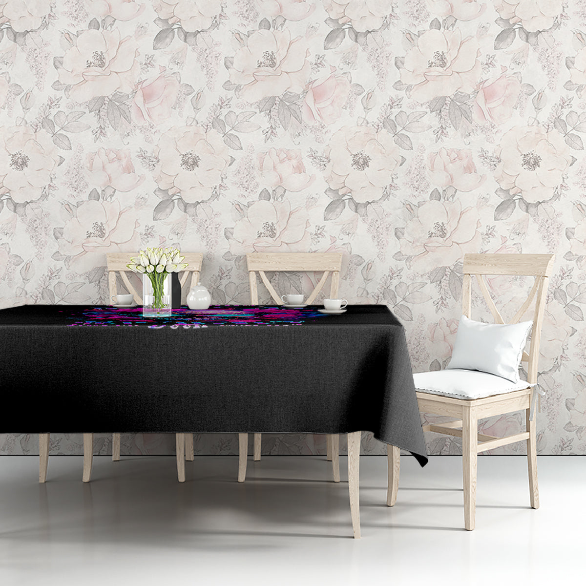 Black tablecloth with centered colorful sugar skull design on a dining table