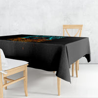 Black tablecloth draped over dining table with flame skull design and overhanging edge