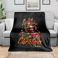 Black throw blanket draped over a sofa, skeleton Santa 'Rockin' Around' design.