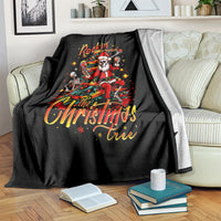 Black throw blanket over a couch seat with skeleton Santa 'Rockin' Around the Christmas Tree'.
