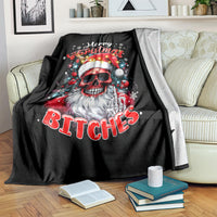 Black skeleton Santa blanket folded on couch with Merry Christmas and 'BITCHES' text