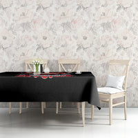 Black Christmas tablecloth on table with skeleton Santa design along the front edge